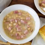 Feature image of a close up overhead shot of a bowl of Creamy Great Northern Beans and Ham.