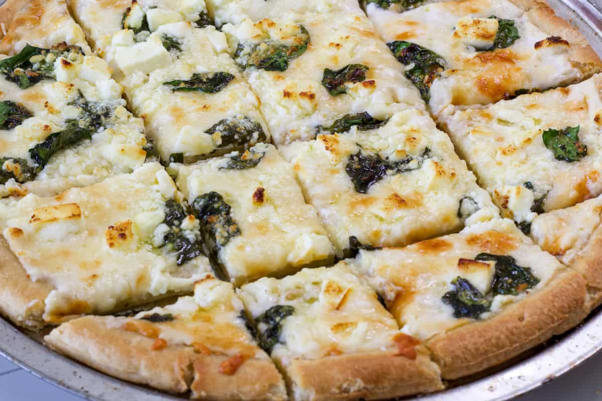 Side view of part of the baked pizza after it's been cut into squares.