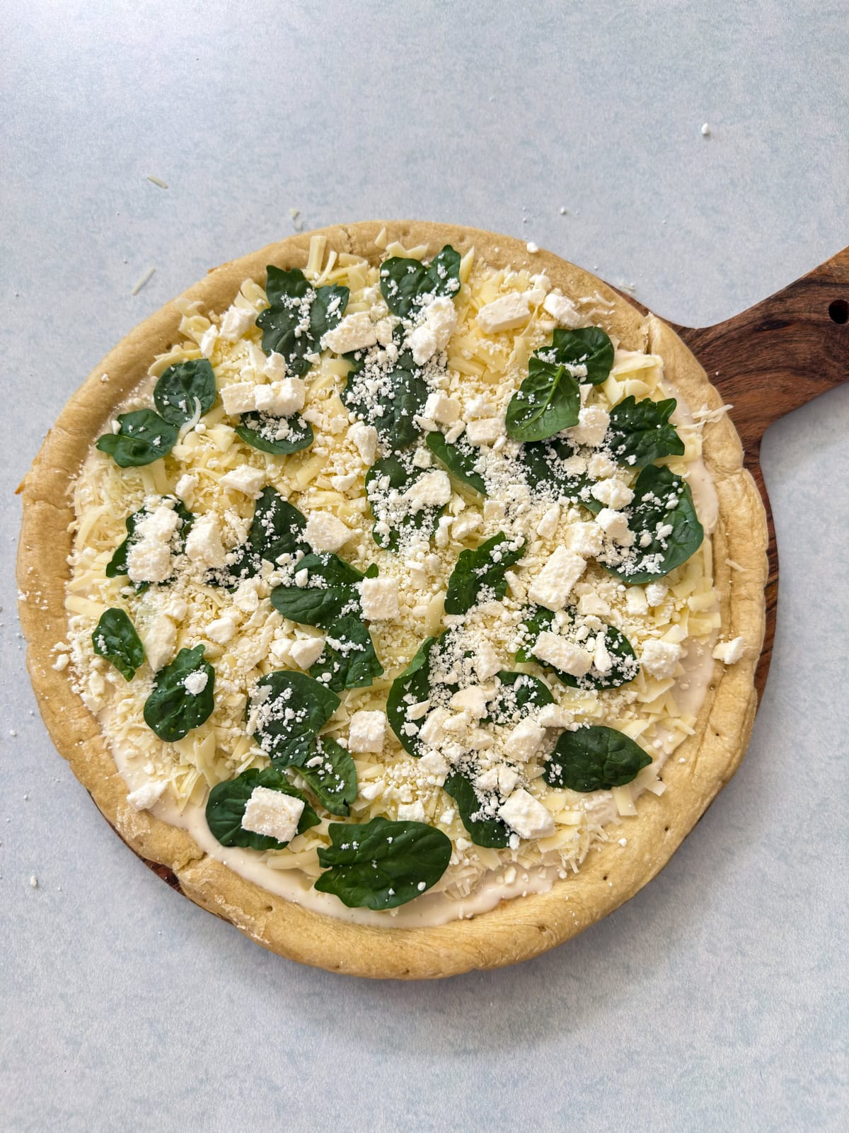 The feta cheese added on top of the spinach and it's ready to go into the oven.