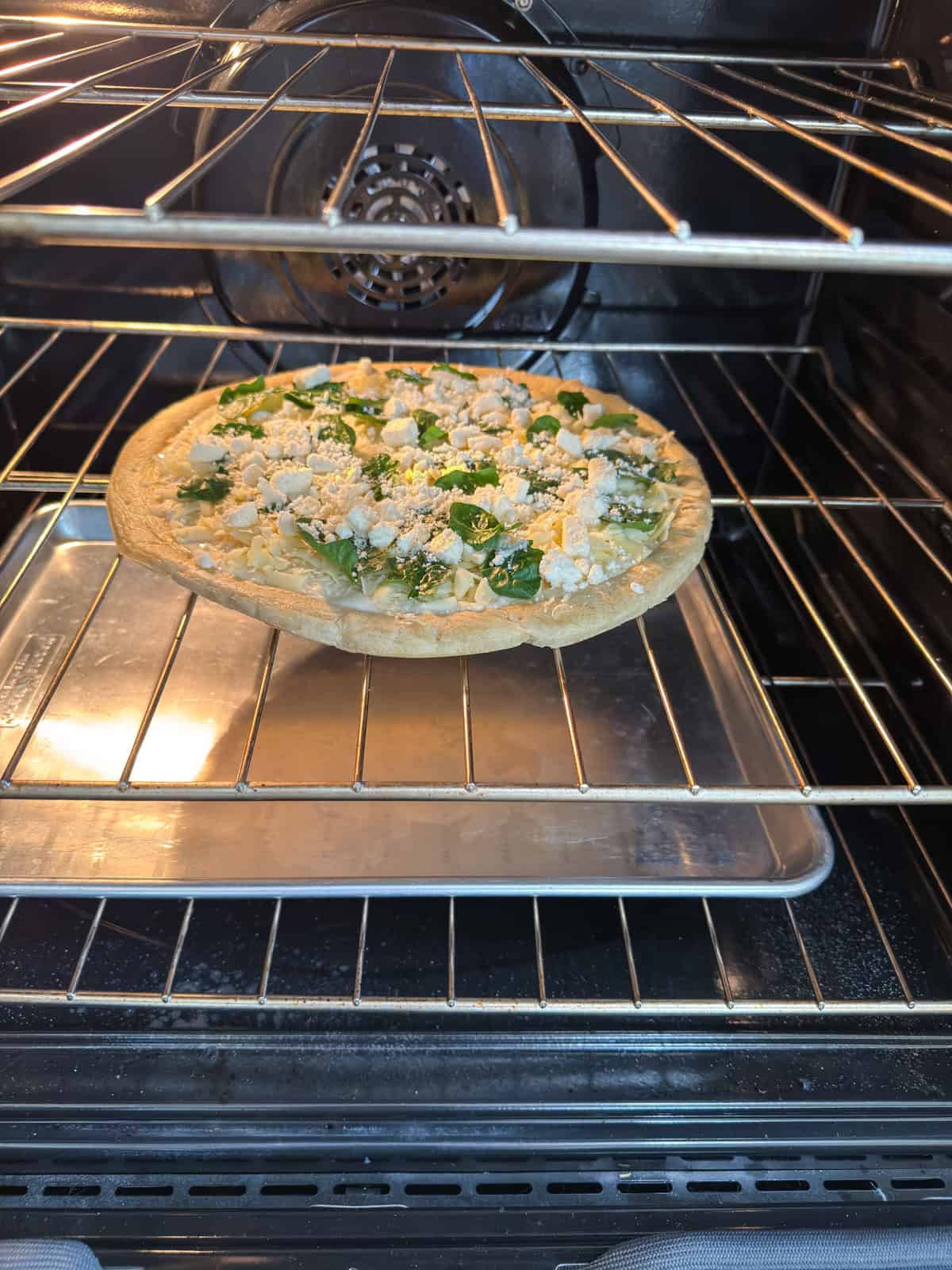 The pizza on the oven rack and a large sheet pan on the rack under it to catch any spills.