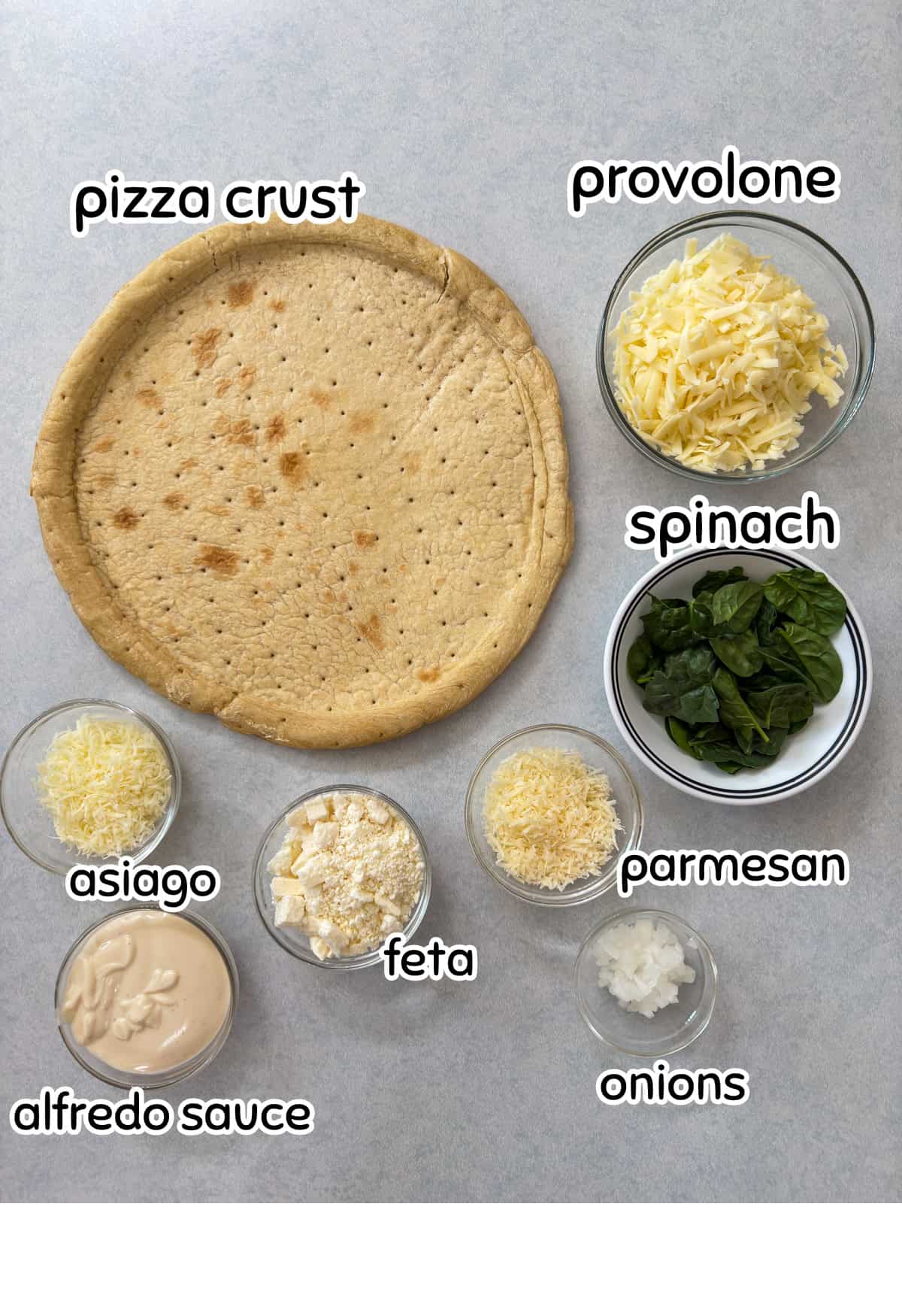 All of the ingredients needed to make the Feta Cheese & Spinach White Pizza recipe.