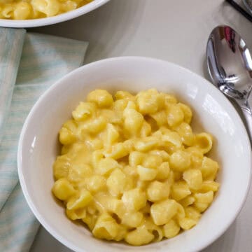 Overhead of one serving of Homemade Shells Mac and Cheese in a white bowl.