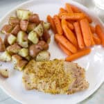 Feature image of an overhead close u view of one serving of Maple Pork Chops & Veggie Dinner on a white plate.