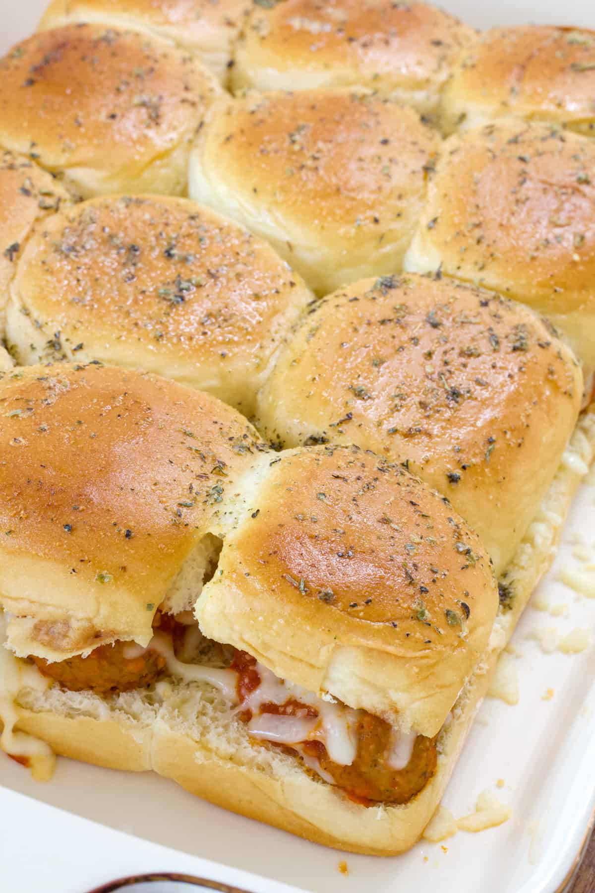 The baking dish filled with the baked Meatball Sliders on Hawaiian Rolls.