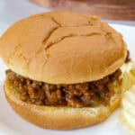 Feature image of a close up of the sloppy joe sandwich on a white plate.