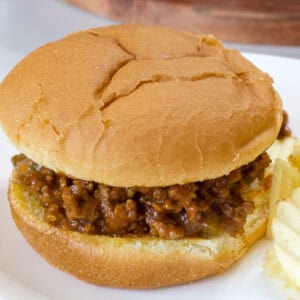 Feature image of a close up of the sloppy joe sandwich on a white plate.