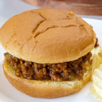 Feature image of a close up of the sloppy joe sandwich on a white plate.