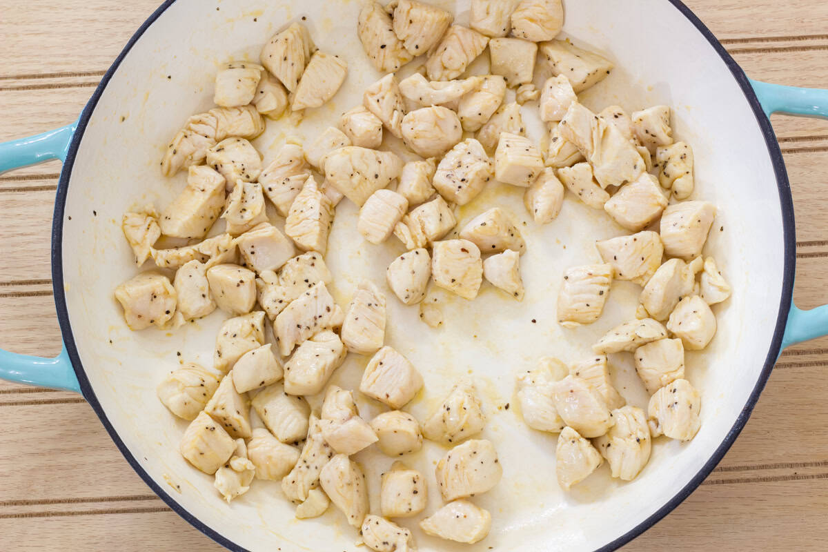 The chicken in the skillet after it's been cooked.