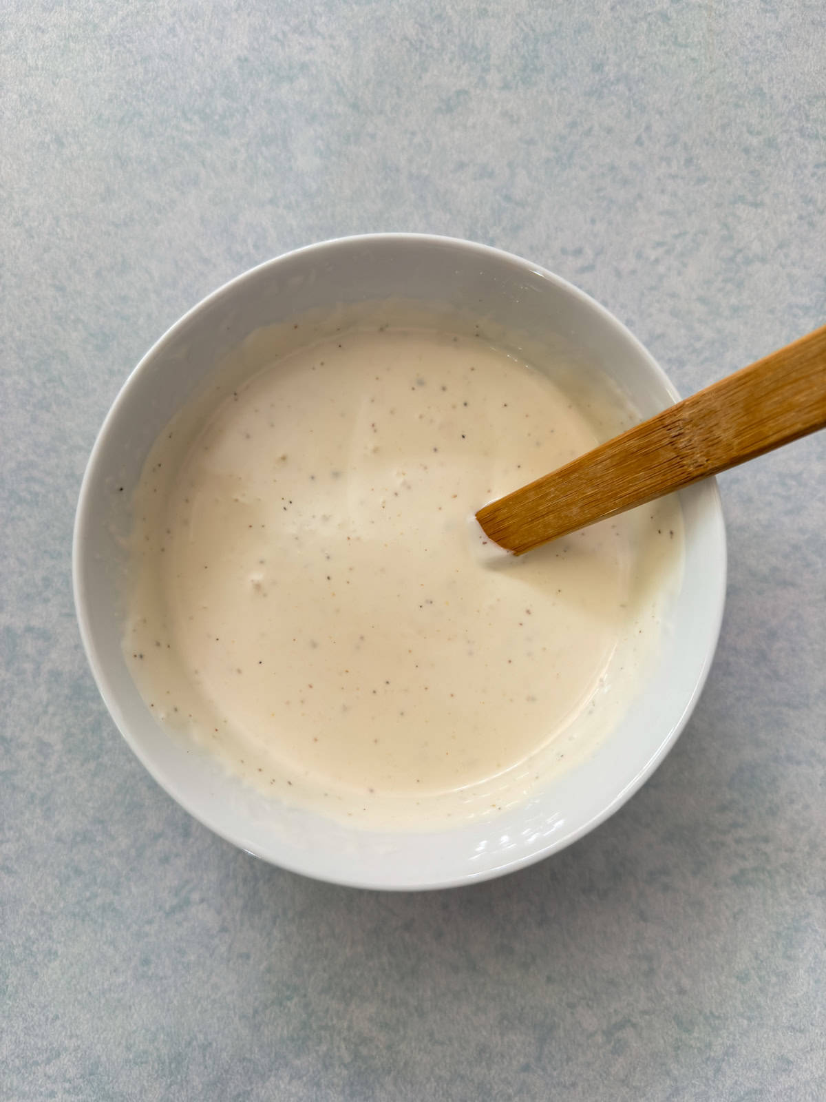 The ranch dressing and milk mixed together in a small bowl.