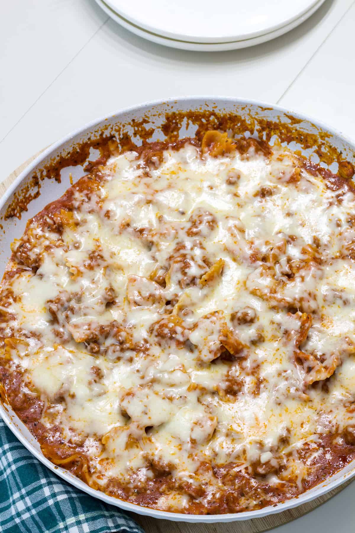 A skillet with the entire batch of Homemade Hamburger Helper Lasagna topped with melty cheese.