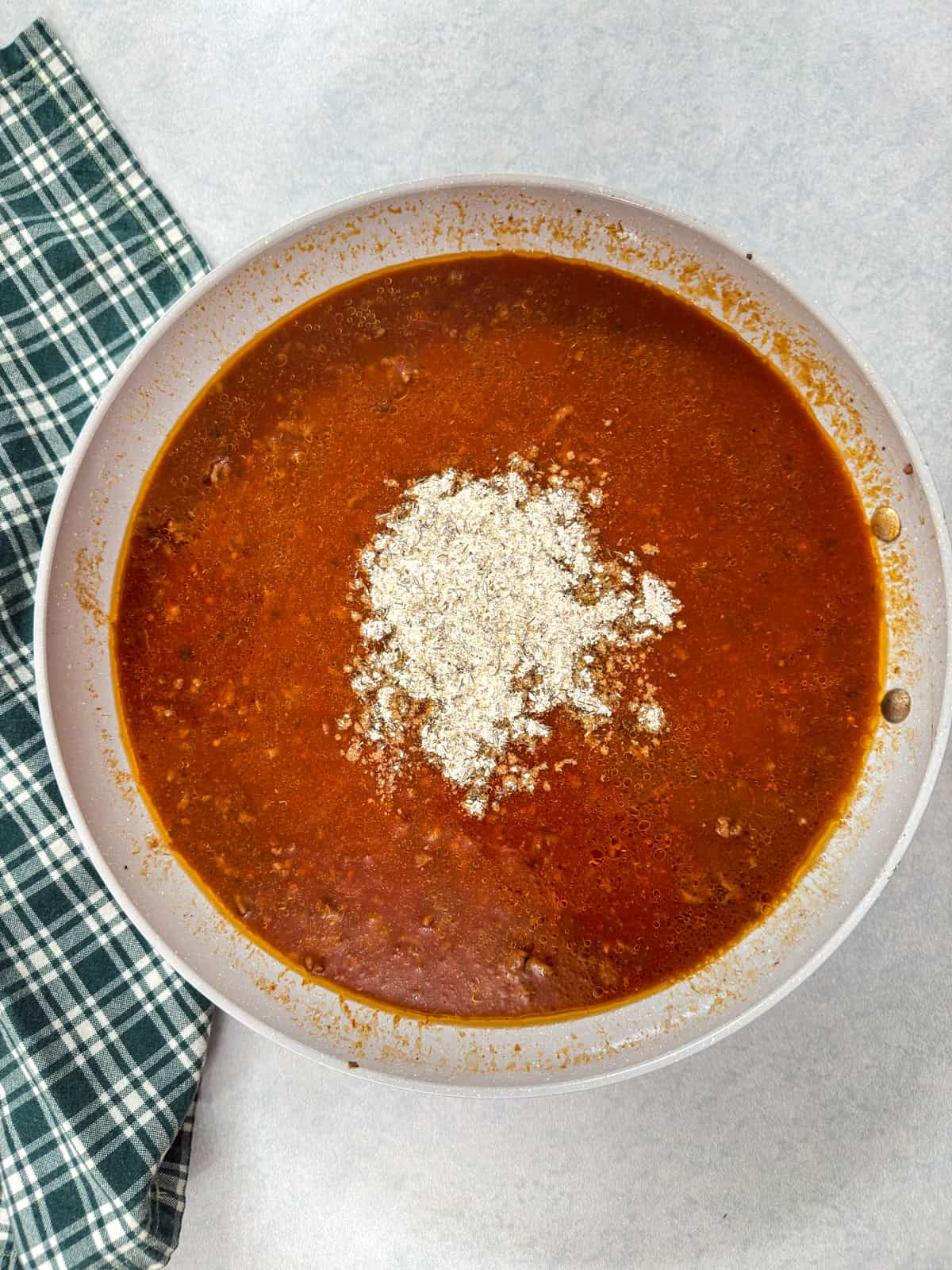 The seasoning mixture added into the skillet with the other ingredients.