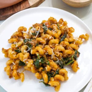 Overhead shot of a plate of pasta with spinach and cheese.