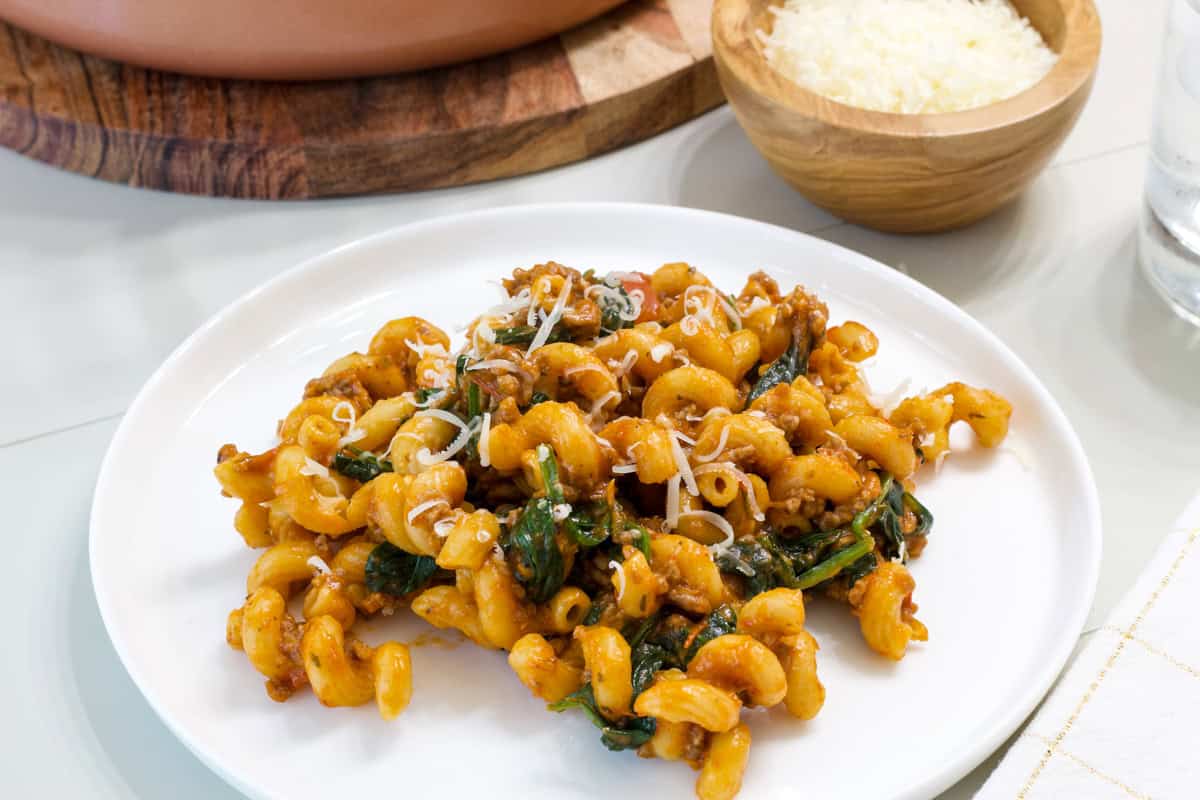 One serving of One Pot Ground Beef & Spinach Pasta on a white plate.