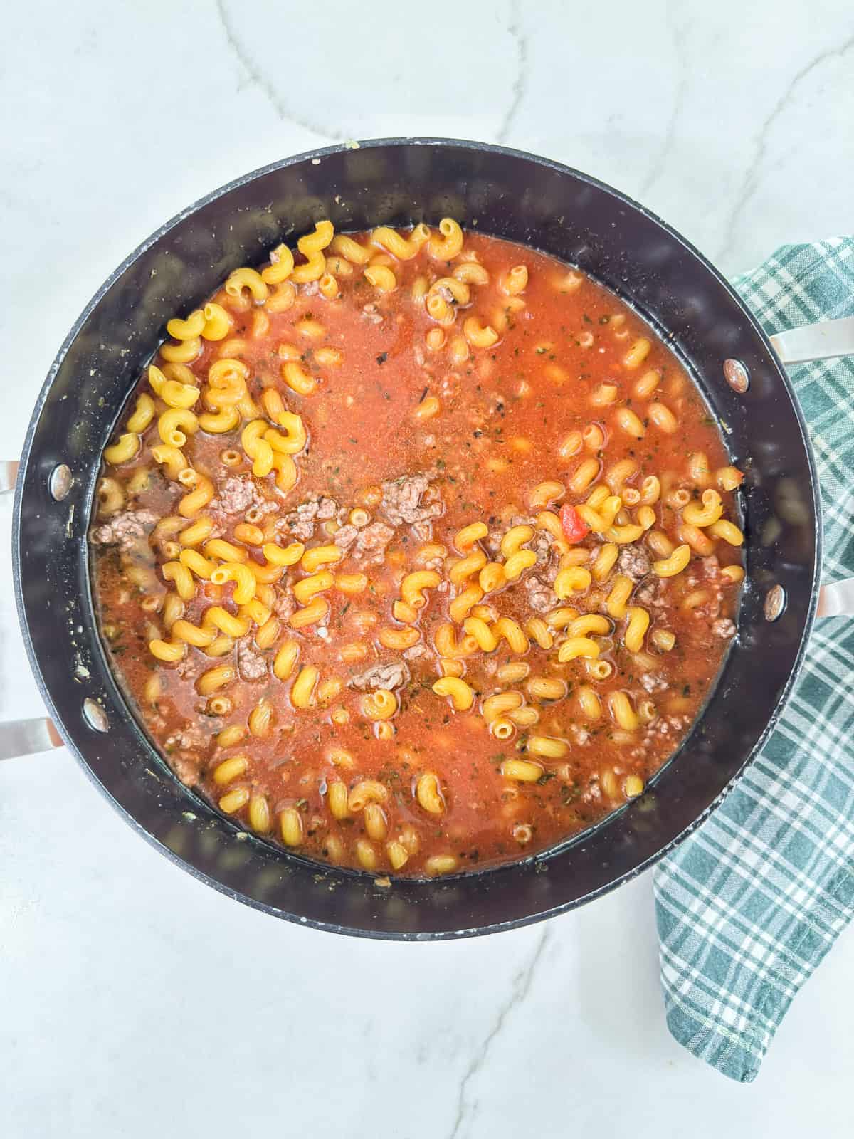 A pan filled with pasta and meat sauce