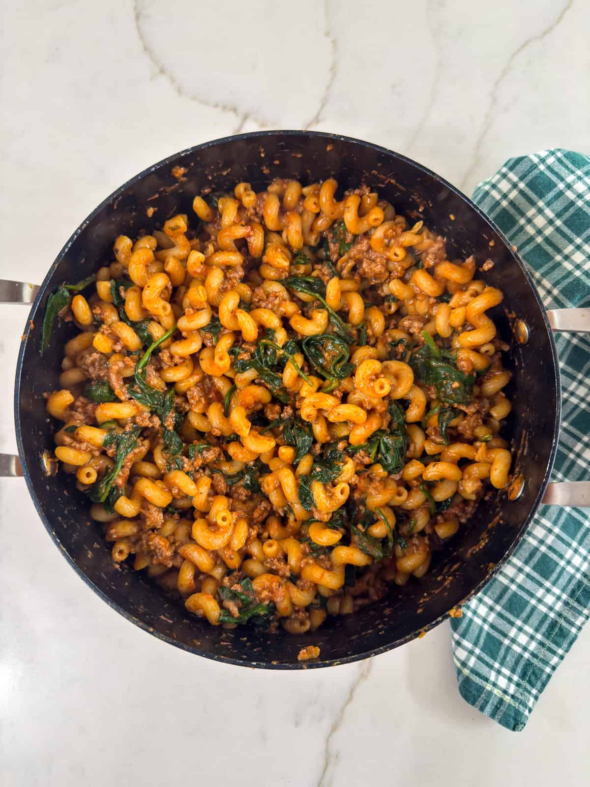 A pot filled with the entire batch of One Pot Ground Beef & Spinach Pasta.
