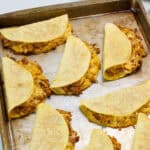Feature image of the baked tacos still on the rimmed baking sheet.