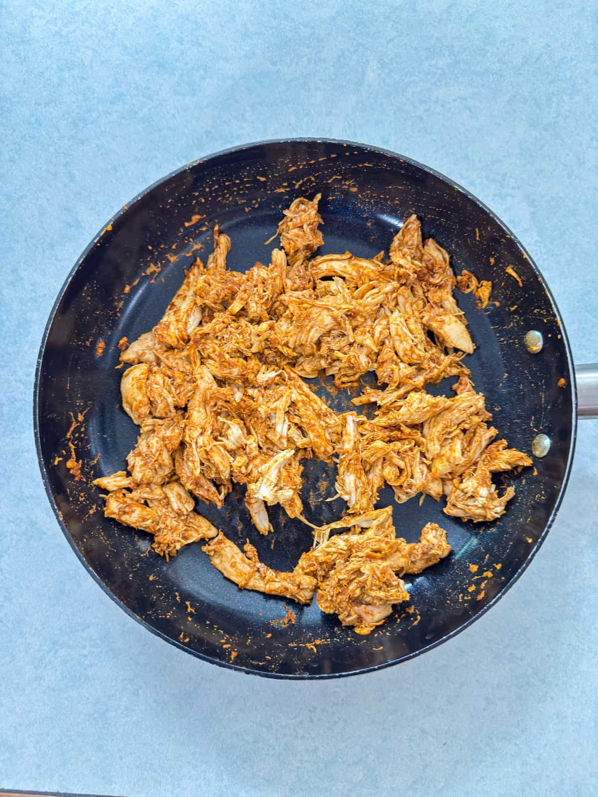 The rotisserie chicken, taco seasoning, water and lime juice after being warmed up.