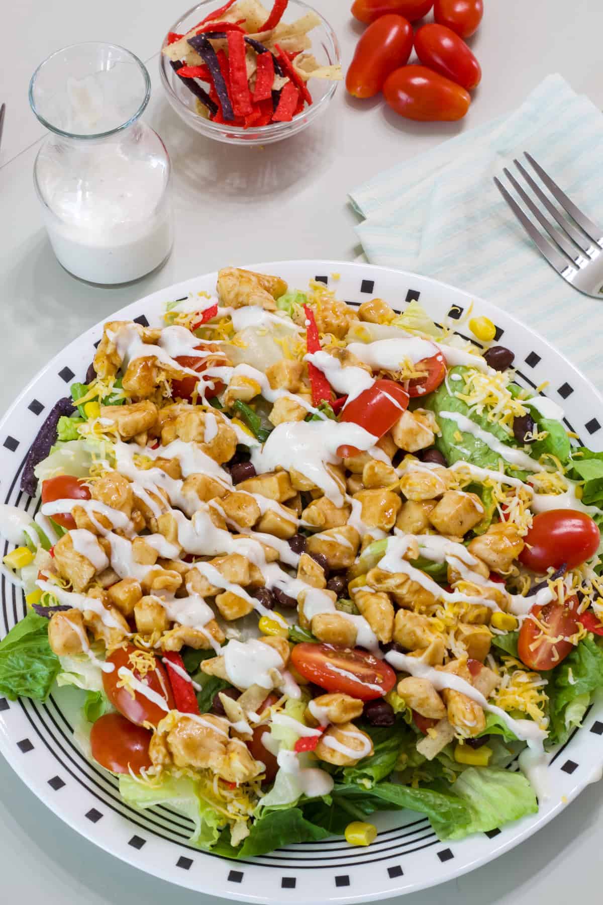 One Southwest BBQ Chicken Salad on a white and black plate.