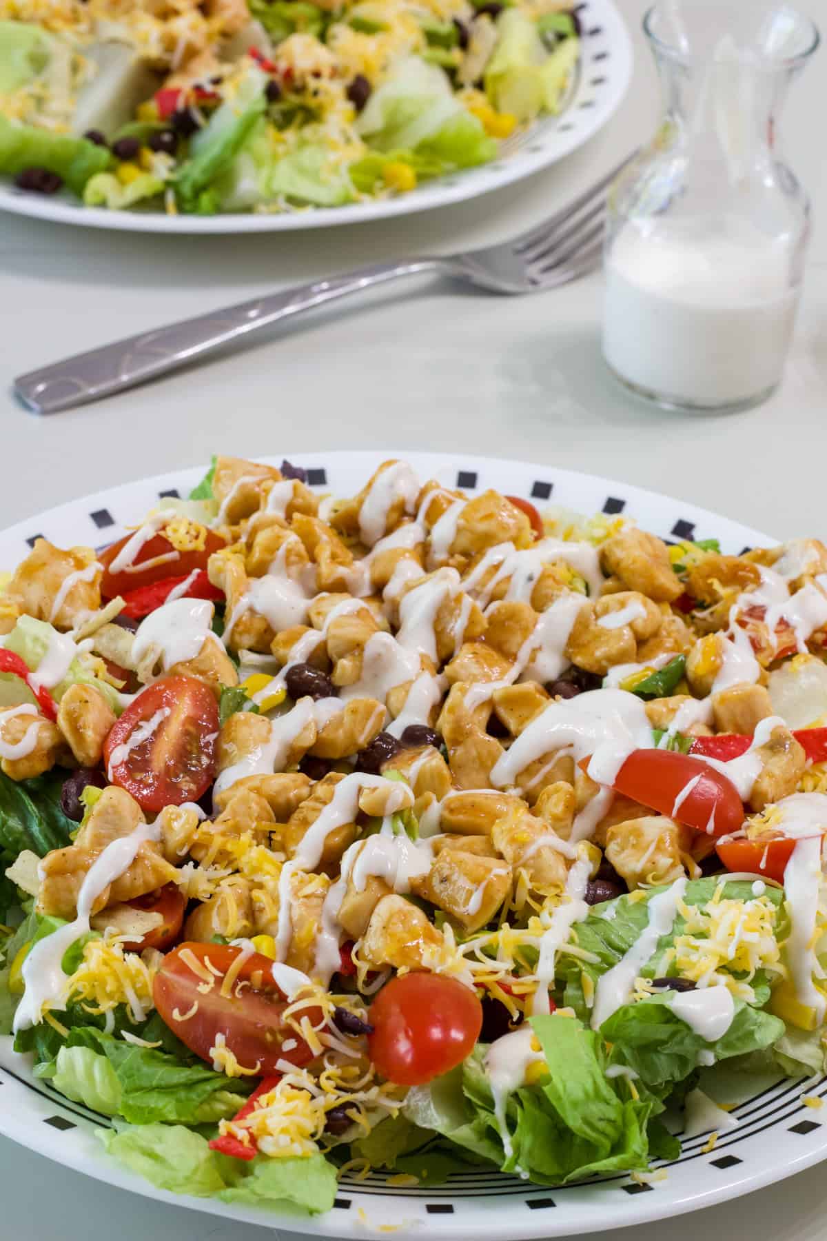 One salad in the foreground and part of the second salad is visible in the background.