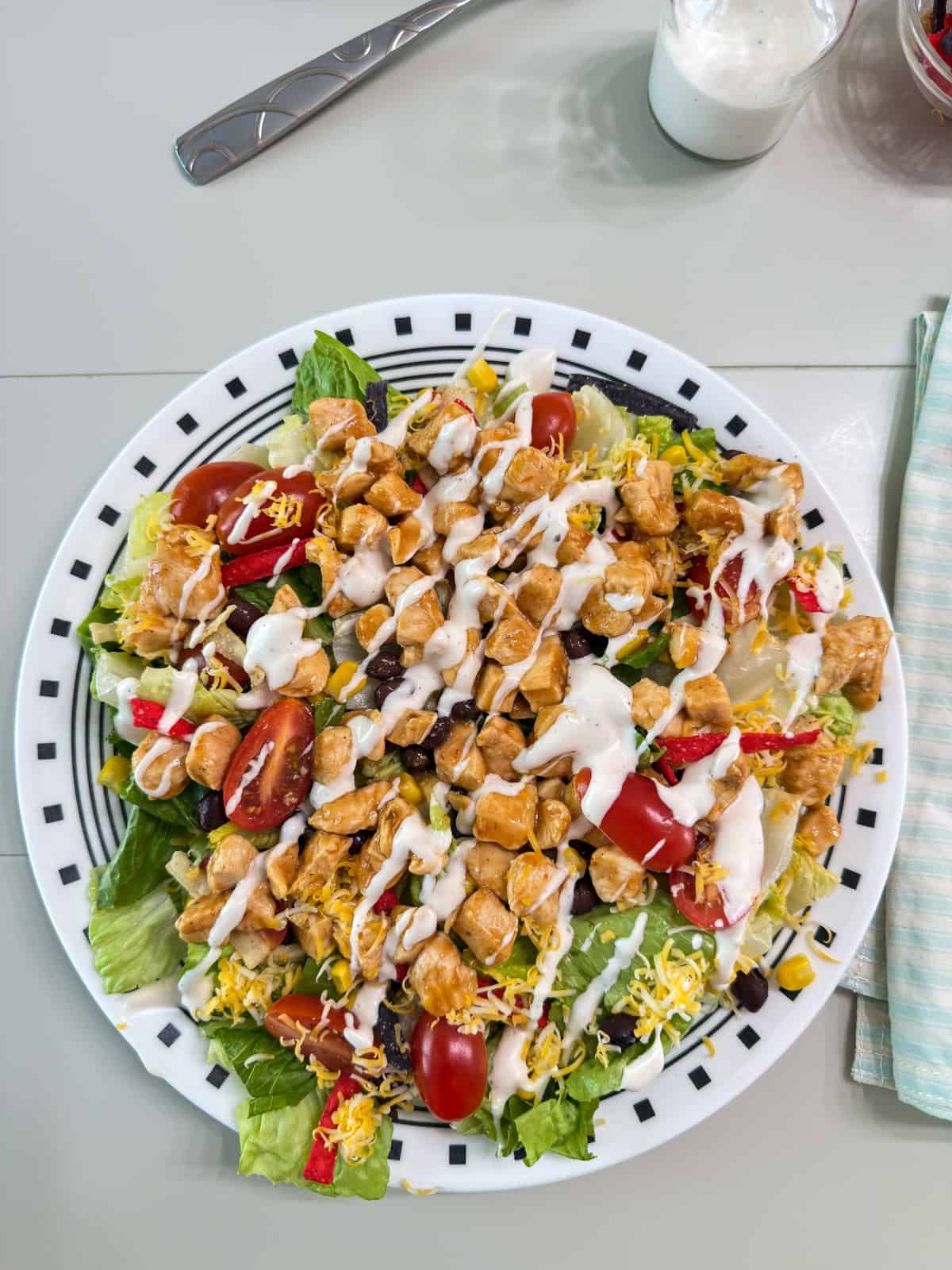 One finished salad after all ingredients, including the dressing, have been added.